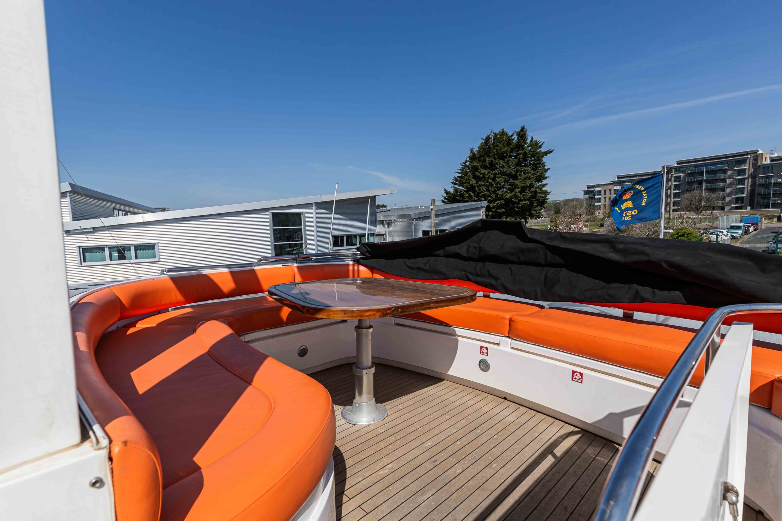 Dated exterior yacht deck with orange cushions