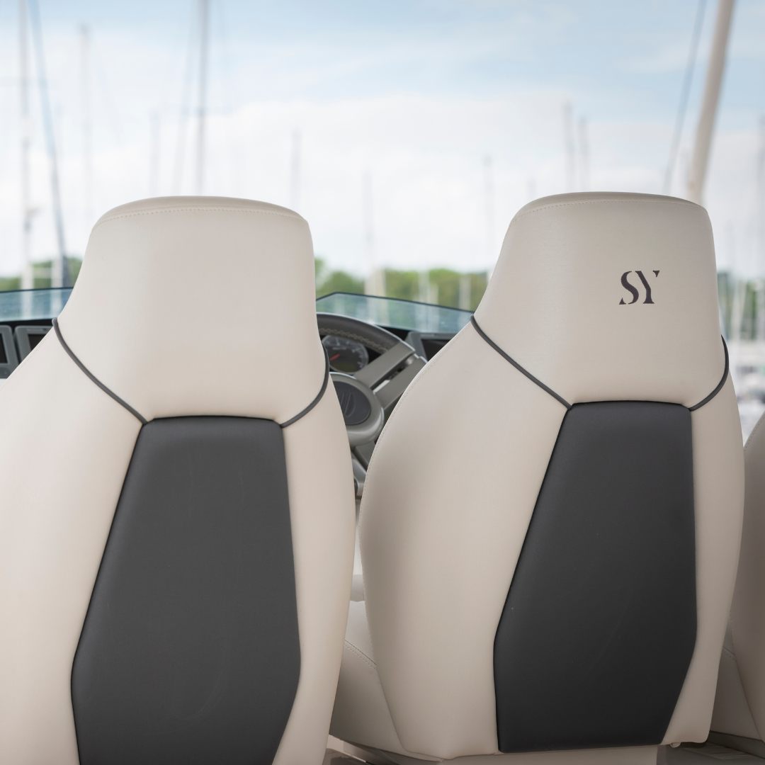 Back of the helm seats of a Fairline Squadron 58 which have been reupholstered in white and grey