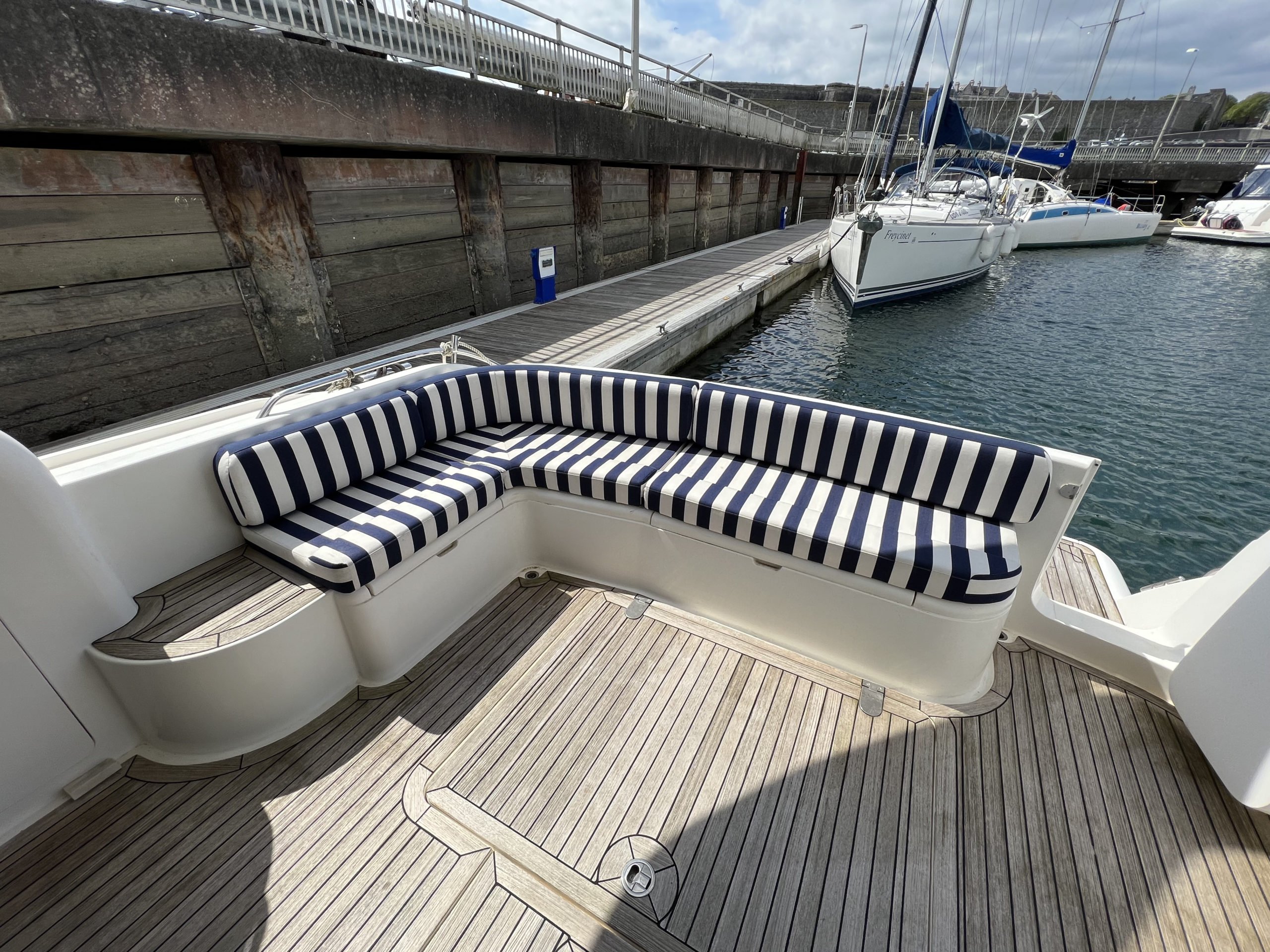 Princess 460 showing the cockpit with tired teak and upholstery